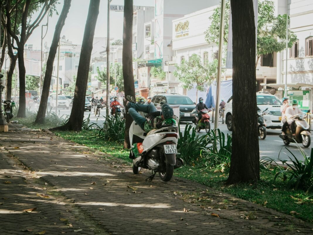 Photo by Anh Vy a motor scooter parked on the side of the road