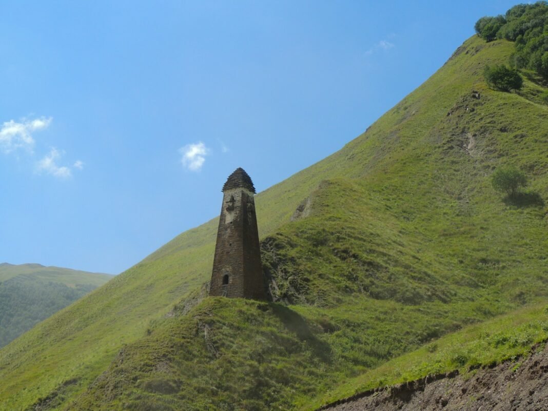 Photo by Marishka Tsiklauri green mountain under blue sky during daytime