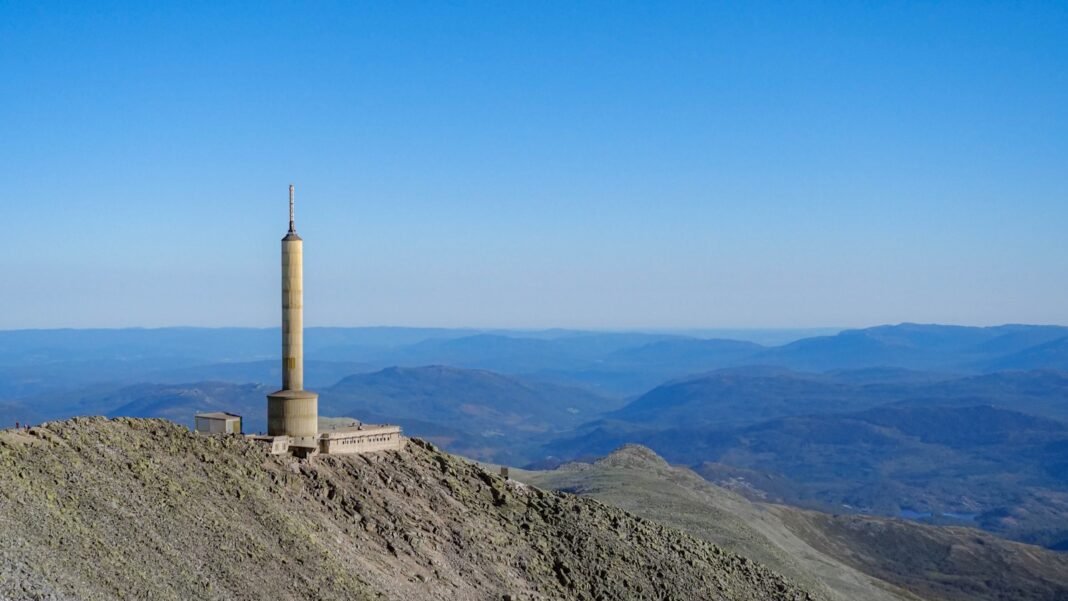 Photo by Jack White A very tall tower on top of a mountain