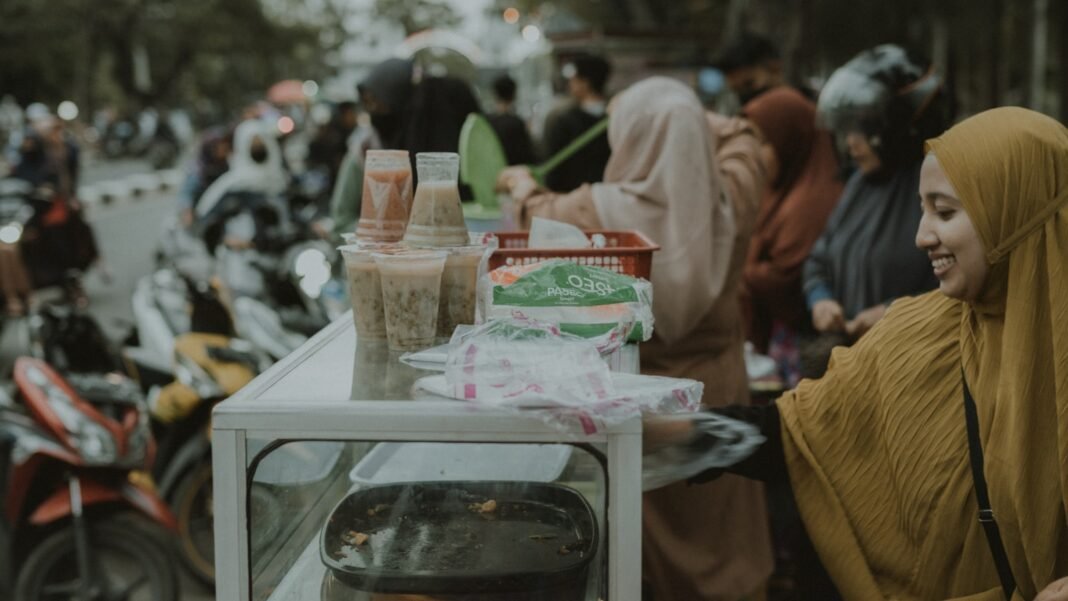 Photo by Umar ben a woman standing in front of a table with food on it