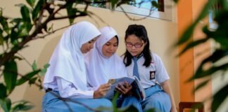 Profil SMAN 00 Banjar woman in white hijab sitting on bed