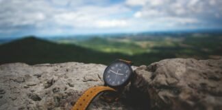 20 Gurindam Tentang Budi Luhur round black analog watch on stone